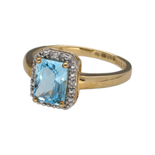 Load image into Gallery viewer, New 9ct Yellow and White Gold Diamond &amp; Blue Topaz Set Halo Ring in size N with the weight 3 grams. The blue topaz stone is 9mm by 6mm and there is approximately 0.02ct of diamond content in total
