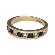 Load image into Gallery viewer, New 9ct Yellow Gold 0.52ct Diamond &amp; Sapphire Set Band Ring in size N with the weight 3.10 grams. The front of the band is 5mm wide and the sapphire stone is 3mm diameter. There is approximately 0.52ct of diamond content in total
