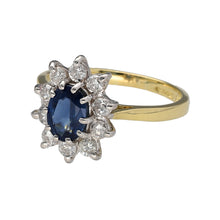 Load image into Gallery viewer, Preowned 18ct Yellow and White Gold Diamond &amp; Sapphire Set Cluster Ring in size L to M with the weight 3.40 grams. The sapphire stone is 7mm by 5mm and there are ten brilliant cut diamonds set around it. There is approximately 40pt of diamond content in total
