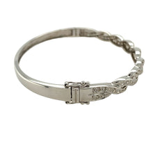 Load image into Gallery viewer, Preowned 9ct White Gold &amp; Diamond Set Twisted Hinged Bangle with the weight 12.40 grams. The front of the bangle is 6mm and the bangle diameter is 6.5cm
