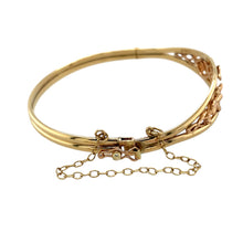 Load image into Gallery viewer, Preowned 9ct Yellow and Rose Gold Clogau Tree of Life Bangle with a safety chain with the weight 11 grams. The front of the ring is 12mm high and the bangle diameter is 6cm
