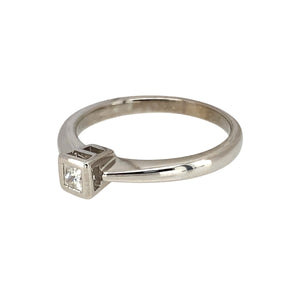 Preowned 9ct White Gold & Diamond Rubover Set Princess Cut Solitaire Ring in size M with the weight 2.20 grams. The diamond is approximately 0.15ct of diamond content