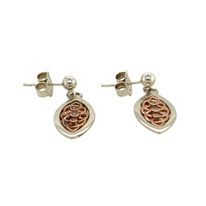 Add a touch of elegance and heritage to your jewellery collection with these pre-owned 925 silver with 9ct rose gold & diamond set Clogau Celtic knot drop earrings, featuring:

Design: Intricate Celtic knot drop earrings, symbolising eternity and interconnectedness.
Material: A combination of 925 sterling silver and 9-carat rose gold, creating a striking two-tone contrast.
Gemstones: Set with diamonds, adding a subtle sparkle to the design.
