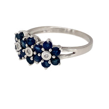 Load image into Gallery viewer, Preowned 9ct White Gold Diamond &amp; Sapphire Set Trilogy Flower Cluster Ring in size N with the weight 2.10 grams. The front of the ring is 8mm high and the sapphire stones are each 2mm diameter
