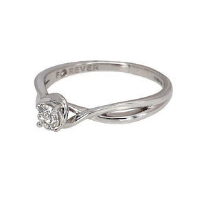 Preowned 18ct White Gold & Diamond Set Solitaire Ring with crossover shoulders. The ring is in size R with the weight 2.80 grams. The diamond is approximately 25pt with the approximate clarity i1 and colour I - J