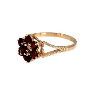 Preowned 9ct Yellow Gold & Garnet Set Flower Cluster Ring in size L to M with the weight 1.70 grams. The front of the ring is 10mm high