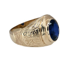 Load image into Gallery viewer, Preowned 9ct Yellow Gold &amp; Blue Stone Set University Style Signet Ring in size Z+3 with the weight 9.60 grams. The front of the ring is 19mm high and the blue stone is approximately 12mm by 10mm. The shoulders of the ring have bird on one shoulders and a shield shaped crest on the other
