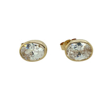 Load image into Gallery viewer, Preowned 9ct Yellow Gold &amp; Cubic Zirconia Rubover Set Oval Stud Earrings with the weight 1.80 grams. The stones are each 8mm by 6mm
