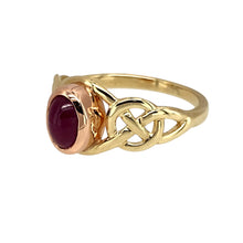 Load image into Gallery viewer, Preowned 9ct Yellow and Rose Gold &amp; Ruby Cabochon Set Clogau July Birthstone Ring in size O with the weight 2.70 grams. The ruby stone is approximately 7mm by 5mm and the shoulders of the ring have a Celtic pattern
