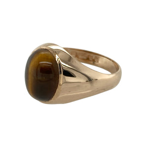 Add earthy elegance to your jewellery collection with this pre-owned 9ct yellow gold and cabochon set tiger's eye oval signet ring, featuring:

Design: A classic oval signet style showcasing a smooth cabochon-cut tiger's eye stone with natural, golden-brown chatoyancy.
Material: 9-carat yellow gold, offering a warm, polished finish that enhances the stone’s natural tones.
Gemstone Detail: Set with a 10mm by 8mm oval cabochon tiger's eye stone, adding depth and character to the design.
