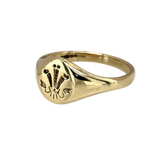 Load image into Gallery viewer, Add a classic and symbolic piece to your jewellery collection with this pre-owned 9ct yellow gold Welsh Three Feathers oval signet ring, featuring:

Design: A traditional oval signet ring engraved with the iconic Welsh Three Feathers emblem, representing heritage and pride.
Material: 9-carat yellow gold, offering a warm and timeless appeal.
Size &amp; Weight: Designed in size K, with a well-balanced weight of 2.40 grams for a comfortable fit.
Front Dimensions: Measures 8mm high, making it a refined yet noticeab
