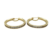 Load image into Gallery viewer, Add a touch of sparkle and elegance to your jewellery collection with these pre-owned 9ct yellow gold &amp; cubic zirconia set hoop creole earrings, featuring:

Design: Classic hoop creole earrings, adorned with cubic zirconia for added brilliance and sophistication.
Material: 9-carat yellow gold, offering a warm and timeless appeal.
Gemstones: Set with cubic zirconia, providing a dazzling and refined finish.
Weight: A substantial 6.10 grams, ensuring durability while remaining comfortable to wear.

