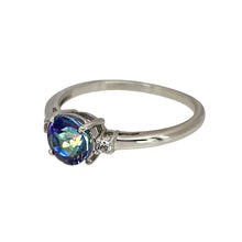 Load image into Gallery viewer, Add a unique and vibrant touch to your jewellery collection with this pre-owned 9ct white gold mystic topaz &amp; cubic zirconia set ring, featuring:

Design: A stunning mystic topaz ring, accented with sparkling cubic zirconia for added brilliance.
Material: 9-carat white gold, offering a sleek and modern appeal.
Gemstones: Features a 6mm diameter mystic topaz-coloured stone, displaying captivating iridescent hues, complemented by cubic zirconia accents.
Size &amp; Weight: Designed in size N
