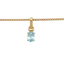 Load image into Gallery viewer, Add a touch of elegance and colour to your jewellery collection with this pre-owned 9ct yellow gold &amp; oval blue topaz set pendant necklace, featuring:

Design: A classic oval blue topaz pendant, set in yellow gold for a timeless and sophisticated look.
Material: 9-carat yellow gold, offering a warm and refined finish.
Gemstone: Features a 6mm by 4mm oval blue topaz, known for its vibrant hue and calming properties.
Chain: Paired with a 16-inch curb chain, creating a delicate and elegant fit.

