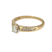 Load image into Gallery viewer, Add a touch of timeless elegance to your jewellery collection with this pre-owned 9ct yellow gold &amp; diamond set solitaire ring, featuring:

Design: A classic solitaire ring, enhanced with diamond-set shoulders for added brilliance and sophistication.
Material: 9-carat yellow gold, offering a warm and luxurious appeal.
Gemstones: Features a central diamond, with a total of approximately 0.33ct of diamond content, complemented by sparkling shoulder diamonds.

