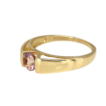 Load image into Gallery viewer, Add a touch of elegance and colour to your jewellery collection with this pre-owned 9ct yellow gold &amp; pink stone solitaire ring, featuring:

Design: A classic solitaire ring, showcasing a single vibrant pink stone for a timeless and sophisticated look.
Material: 9-carat yellow gold, offering a warm and enduring appeal.
Gemstone: Features a 5mm diameter pink stone, adding a delicate yet striking pop of colour.
Size &amp; Weight: Designed in size N, with a well-balanced weight of 2.20 grams for a comfortable fit.
