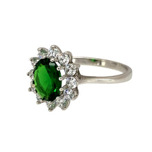 Load image into Gallery viewer, Add a touch of elegance and sophistication to your jewellery collection with this pre-owned 9ct white gold green stone &amp; cubic zirconia set cluster ring, featuring:

Design: A classic cluster ring, showcasing a striking emerald-coloured green stone surrounded by sparkling cubic zirconia for added brilliance.
Material: 9-carat white gold, offering a sleek and modern appeal.
Gemstone: Features an 8mm by 6mm emerald-coloured green stone
