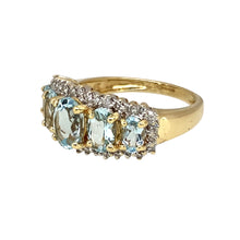 Load image into Gallery viewer, Add a touch of elegance and sophistication to your jewellery collection with this pre-owned 9ct yellow gold diamond &amp; aquamarine set five-stone halo ring, featuring:

Design: A stunning five-stone halo ring, with a dazzling arrangement of diamonds surrounding a striking aquamarine centre.
Material: 9-carat yellow gold, with the diamonds set in white gold to enhance their brilliance.
Gemstones: Features a 7mm by 5mm aquamarine centre stone, known for its serene blue hue
