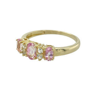 Add a pop of colour and sparkle to your jewellery collection with this pre-owned 9ct yellow gold band ring, featuring:

Design: A classic band style with a vibrant centre stone and white cubic zirconia accents for added brilliance.
Material: 9-carat yellow gold, offering a warm and polished finish.
Gemstone Detail: Features a 6mm by 4mm pink cubic zirconia at the centre, flanked by white stones for contrast and shimmer.
Size & Fit: Designed in size P, ensuring a comfortable and flattering fit.
