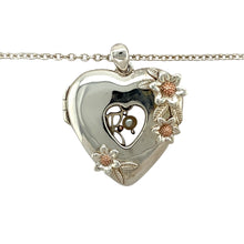 Load image into Gallery viewer, Add a beautifully sentimental piece to your jewellery collection with this pre-owned 925 silver with 9ct rose gold Clogau heart flower patterned locket pendant necklace, featuring:

Design: An intricately detailed heart-shaped locket with a delicate flower pattern, adding charm and elegance.
Material: A combination of 925 sterling silver and 9-carat rose gold, creating a classic two-tone finish.
Chain: Paired with an 18-inch Clogau belcher chain, complementing the pendant with a timeless style.

