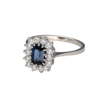 Load image into Gallery viewer, Preowned 18ct White Gold Diamond &amp; Sapphire Set Cluster Ring in size K with the weight 2.80 grams. The front of the ring is 11mm high and the sapphire stone is 6mm by 4mm. There is approximately 42pt of diamond content in total
