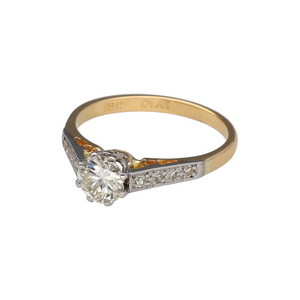 Preowned 18ct Yellow Gold & Platinum Diamond Set Solitaire Ring in size M with the weight 2.80 grams. The shoulders are set with diamonds and the center diamond is approximately 66pt. The diamonds are approximate clarity VS2 and colour K - M