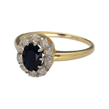 Load image into Gallery viewer, Preowned 18ct Yellow and White Gold Diamond &amp; Sapphire Set Cluster Ring in size S with the weight 3.60 grams. The sapphire stone is 8mm by 6mm and there is approximately 30pt of diamond content in total
