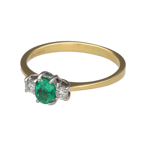 Preowned 18ct Yellow and White Gold Diamond & Emerald Set Trilogy Ring in size R with the weight 2.80 grams. The emerald stone is approximately 6mm by 5mm and there is approximately 12pt of diamond content in total