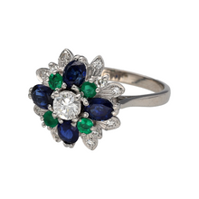 Load image into Gallery viewer, Preowned 18ct White Gold Diamond Sapphire &amp; Emerald Set Flower Cluster Cocktail Ring in size N with the weight 5.20 grams. The front of the ring is 16mm high. The sapphire stones are each 5mm by 3mm and the emerald stones are each 2mm diameter
