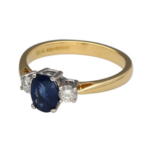 Load image into Gallery viewer, Preowned 18ct Yellow and White Gold Diamond &amp; Sapphire Set Trilogy Ring in size N with the weight 3.50 grams. The oval cut sapphire stone is 7mm by 5mm and there is approximately 0.20ct of diamond content in total
