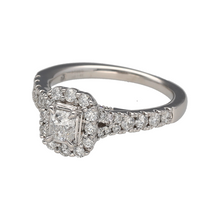 Load image into Gallery viewer, Preowned Platinum &amp; Diamond Set Halo Ring in size K with the weight 6.40 grams. The front of the ring is 10mm high. The ring is made up of an emerald cut diamond in the center with a halo of brilliant cut diamonds at approximately 0.85ct of diamond content in total. The diamonds are approximate clarity Si
