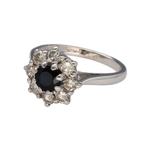 Load image into Gallery viewer, Preowned 18ct White Gold Diamond &amp; Sapphire Set Cluster Ring in size H with the weight 4.50 grams. The sapphire stone is 5mm diameter and there is approximately 0.64ct of diamond content
