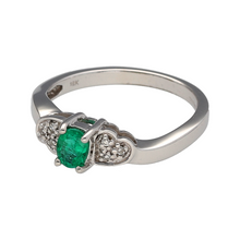 Load image into Gallery viewer, Preowned 18ct White Gold Diamond &amp; Emerald Set Ring in size N with the weight 3.50 grams. The emerald stone is 5mm by 4mm and the shoulders have a heart shaped pattern
