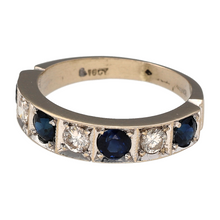 Load image into Gallery viewer, Preowned 18ct White Gold Diamond &amp; Sapphire Set Band Ring in size O with the weight 5.30 grams. There are four round cut sapphires which are each 4mm diameter with three brilliant cut diamonds at approximately 0.14ct each. There is approximately 0.42ct of diamond content set in total
