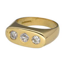 Load image into Gallery viewer, Make a bold statement with this striking preowned 18ct yellow gold &amp; diamond set trilogy signet ring, featuring:

Design: A sophisticated signet style, enhanced by a classic trilogy of dazzling diamonds, symbolising past, present, and future.

Material: Crafted from 18-carat yellow gold, offering a rich and timeless finish.

Size &amp; Weight: Size O, with a substantial weight of 13.50 grams for a luxurious feel.

Front Dimensions: The front of the band measures 8mm wide, providing a strong yet elegant presence
